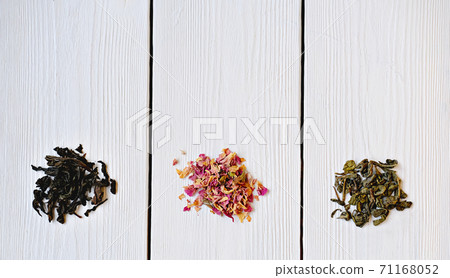 Different types of tea leaves on wooden background.  71168052