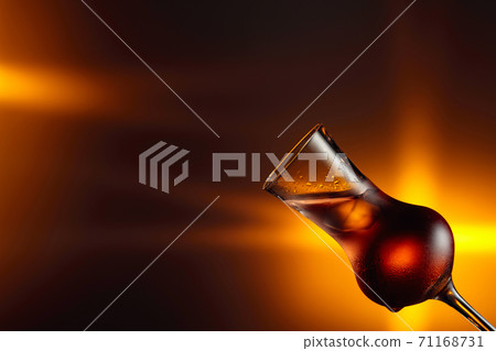 Steamed glass with strong alcoholic drink. Steamed glass with strong alcoholic drink. 71168731