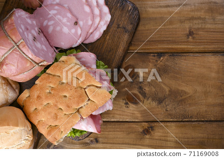 Traditional Italian antipasti mortadella on a wooden plate 71169008