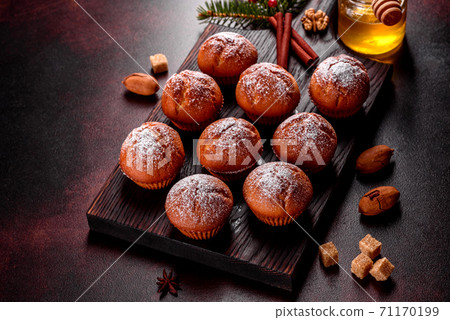 Beautiful delicious fresh cocoa muffins on the Christmas table 71170199