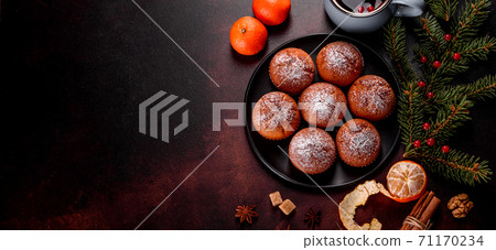 Beautiful delicious fresh cocoa muffins on the Christmas table Beautiful delicious fresh cocoa muffins on the Christmas table 71170234
