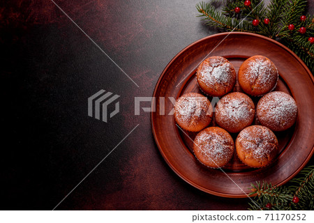 Beautiful delicious fresh cocoa muffins on the Christmas table 71170252
