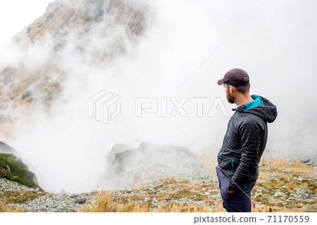 handsome male hiker in foggy mountains social distancing handsome male hiker in foggy mountains social distancing 71170559