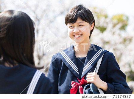 Junior high school students having fun talking with friends 71174587