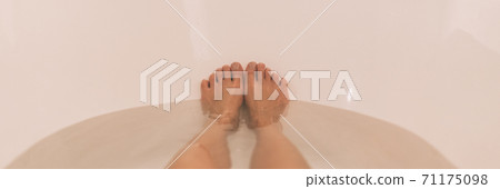 Bath woman relaxing in bathtub at home with view of feet soaking in hot water banner panorama Bath woman relaxing in bathtub at home with view of feet soaking in hot water banner panorama 71175098