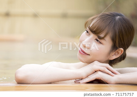 A young woman taking a leisurely open-air bath A young woman taking a leisurely open-air bath 71175757