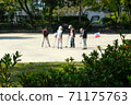 Elderly people enjoying gateball in the park 71175763