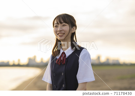 Asian female high school student walking on the beach Asian female high school student walking on the beach 71178430