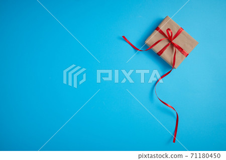 Gift box with a red bow on a blue Gift box with a red bow on a blue 71180450