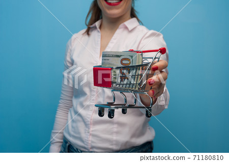 Young woman holding a toy grocery basket 71180810