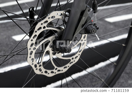 bicycle parts disc brake bike front wheel in close up. bicycle parts disc brake bike front wheel in close up. 71181159