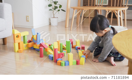 Kids playing with blocks in the living room Kids playing with blocks in the living room 71181894
