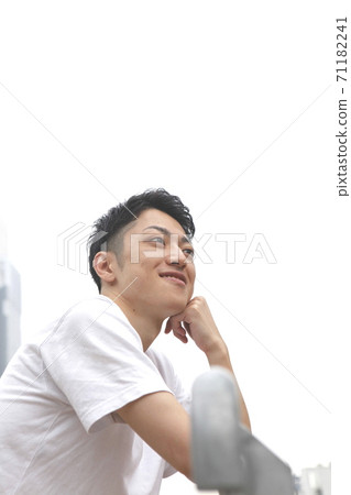 Young man lifestyle image smiling and looking up 71182241