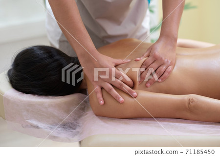 Caucasian woman getting a back massage in the spa salon 71185450