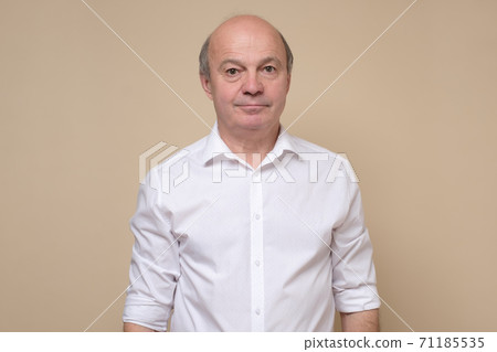 Elegant senior bald man smiling confident at camera. Elegant senior bald man smiling confident at camera. 71185535