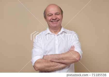 Elegant senior bald man smiling confident at camera. Elegant senior bald man smiling confident at camera. 71185536