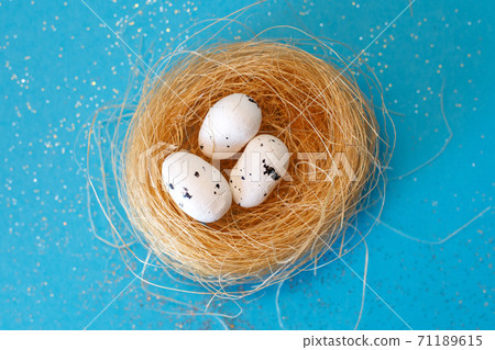 quail eggs in the nest on a blue background close. Easter concept. Happy Easter. 71189615