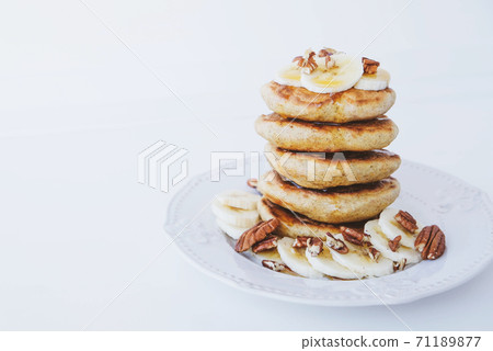 Stack of homemade small thick pancakes served with fresh blueberries. 71189877