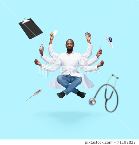 Handsome multi-armed doctor levitating isolated on blue studio background with equipment 71192822