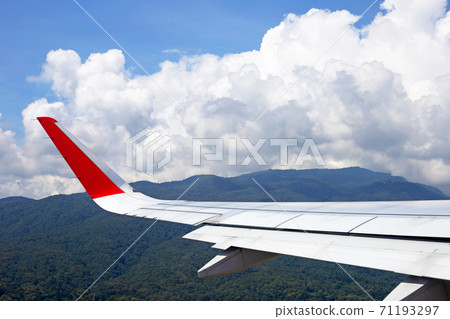 View of mountain, sky, cloud and wing of airplane from window View of mountain, sky, cloud and wing of airplane from window 71193297
