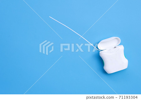 Dental floss on blue background. Copy space Dental floss on blue background. Copy space 71193304