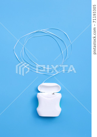 Dental floss on blue background. Copy space Dental floss on blue background. Copy space 71193305