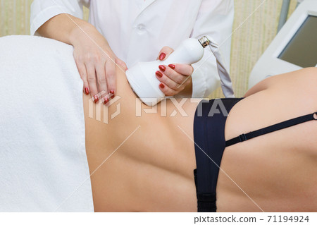 Removal of fat from the sides of the abdomen by cavitation. 71194924