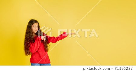 Portrait of young caucasian teen girl with bright emotions isolated on yellow studio background Portrait of young caucasian teen girl with bright emotions isolated on yellow studio background 71195282