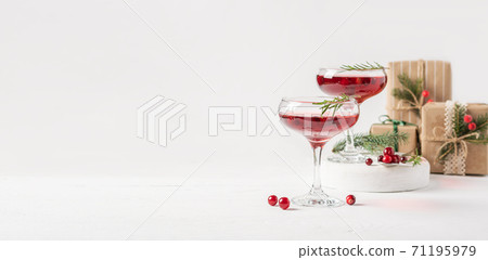 Winter drink cocktail cranberry rosemary white background. Winter drink cocktail cranberry rosemary white background. 71195979