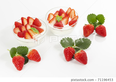 Strawberry yogurt with plenty of strawberries in a glass bowl with a white background Strawberry yogurt with plenty of strawberries in a glass bowl with a white background 71196453