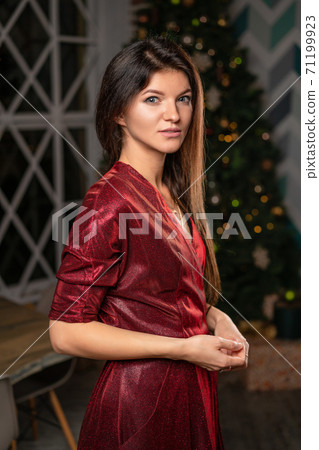 beautiful woman in red dress waiting for new year beautiful woman in red dress waiting for new year 71199923