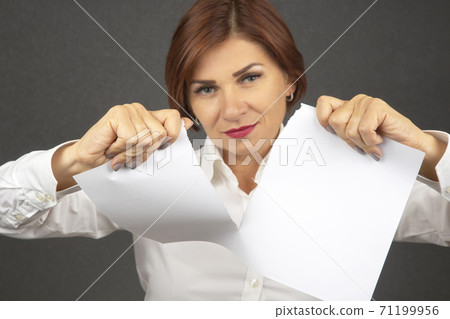 Beautiful business woman tearing white paper in half 71199956