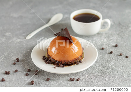 Chocolate mousse cake and cup of coffee on stone table Chocolate mousse cake and cup of coffee on stone table 71200090