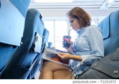 Passenger shipping, woman sitting in cabin of comfortable sea ferry 71201972