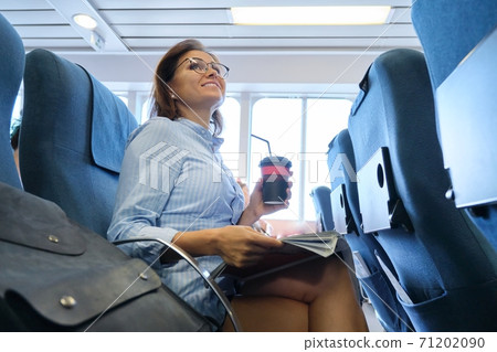 Passenger shipping, woman sitting in cabin of comfortable sea ferry 71202090