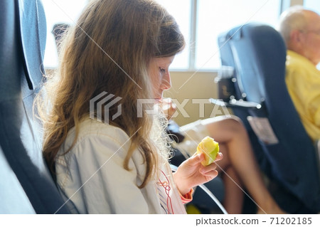 Passenger shipping, girl child with family sitting in cabin comfortable sea ferry 71202185