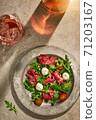 Meat salad on stone surface with wine  71203167