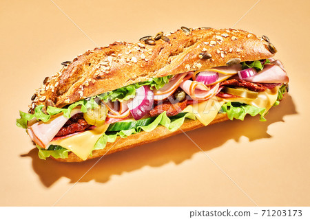 Sandwich with ham and vegetables on light brown Sandwich with ham and vegetables on light brown 71203173