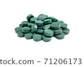 Spirulina algae tablets on a white background. 71206173