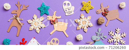 Banner Festive decorations and toys on purple background. Merry Christmas concept Banner Festive decorations and toys on purple background. Merry Christmas concept 71206260