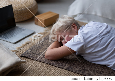 woman relaxes in yoga asana Makarasana or crocodile pose during online lesson woman relaxes in yoga asana Makarasana or crocodile pose during online lesson 71206369