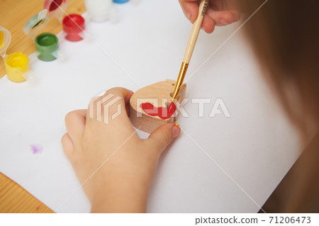 Adorable little girl painting in the room. Idea for DIY indoor activities for children. Shallow dof 71206473