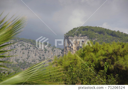 Mountain landscape. The top of the cliff against the background of thunderclouds in the Turkey city of Beldebi. Mountain landscape. The top of the cliff against the background of thunderclouds in the Turkey city of Beldebi. 71206524