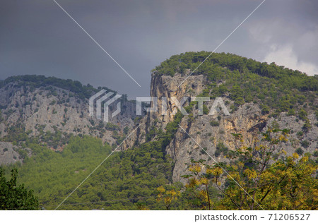 Mountain landscape. The top of the cliff against the background of thunderclouds in the Turkey city of Beldebi. Mountain landscape. The top of the cliff against the background of thunderclouds in the Turkey city of Beldebi. 71206527