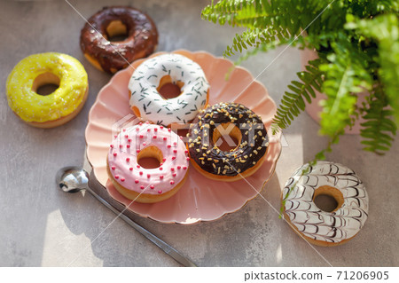 colored different donuts with icing and topping 71206905