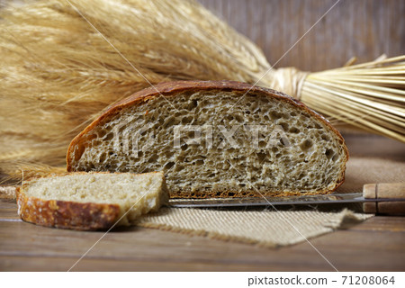 Rustic sliced loaf of bread. Rustic sliced loaf of bread. 71208064
