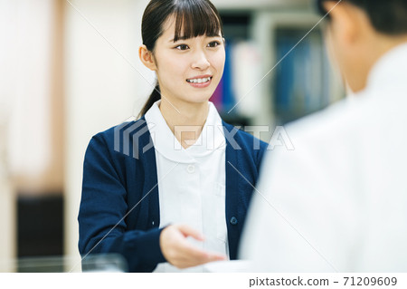 Medical office staff who will guide you at the hospital window Medical office staff who will guide you at the hospital window 71209609