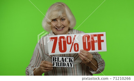 Grandmother showing Black Friday and Up To 70 Percent Off shopping price discount advertisement Grandmother showing Black Friday and Up To 70 Percent Off shopping price discount advertisement 71210266
