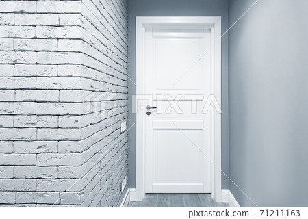 White door in the corridor of the new flat. 71211163