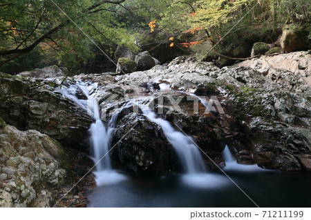 A mountain stream flowing through the rock surface of the canyon A mountain stream flowing through the rock surface of the canyon 71211199